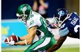 Saskatchewan Roughriders' Chris Getzlaf, 89, scores a touchdown as the Toronto Argonauts' Brandon Isaac defends during CFL action in Toronto on Aug. 8. Getzlaf scored two touchdowns in that game, but has been sidelined by a foot injury ever since. He could return for Friday's game in Hamilton.