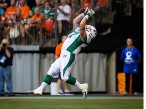 Saskatchewan Roughriders’ Dan Clark makes a reception in the end zone for a touchdown during the second half of a CFL football game against the B.C. Lions in Vancouver, B.C., on Sunday August 24, 2014.