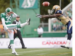 Saskatchewan Roughriders kicker Ray Early (#39) gets illegally contacted by Winnipeg Blue Bombers wide receiver Mike Willie (#99) during the Labour Day Classic held at Mosaic Stadium in Regina, Sask. on Sunday Sep. 6, 2015.