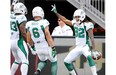 Saskatchewan Roughriders' Naaman Roosevelt, right, celebrates a touchdown against the Ottawa Redblacks with teamates during first half CFL action in Ottawa on Sunday, August 30, 2015. THE CANADIAN PRESS/Justin Tang