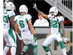 Saskatchewan Roughriders' Naaman Roosevelt, right, celebrates a touchdown against the Ottawa Redblacks with teamates during first half CFL action in Ottawa on Sunday, August 30, 2015. THE CANADIAN PRESS/Justin Tang