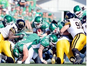 Saskatchewan Roughriders quarterback Brett Smith (#16) dives for the first down against the Hamilton Tiger-Cats at Mosaic Stadium in Regina on Sunday.