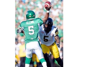 Saskatchewan Roughriders quarterback Kevin Glenn (#5) throws the ball as Hamilton Tiger-Cats defensive end Justin Hickman (#5) closes in at Mosaic Stadium in Regina on Sunday.