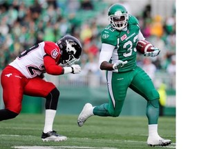 Saskatchewan Roughriders running back Jerome Messam shakes a tackle during first half CFL action against the Calgary Stampeders in Regina on Saturday, August 22, 2015. THE CANADIAN PRESS/Mark Taylor