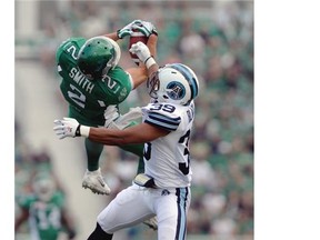 Saskatchewan Roughriders wide receiver Ryan Smith (#2) makes an epic reception while Toronto Argonauts defensive back Matt Black (#39) covers him during a game held at Mosaic Stadium in Regina on Sunday July 5, 2015.