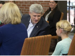 Conservative Leader Stephen Harper speaks with eight-year-old Rebecka Dyok at  Clear Tech during one of two stops in Saskatoon, Wednesday, October 07, 2015.
