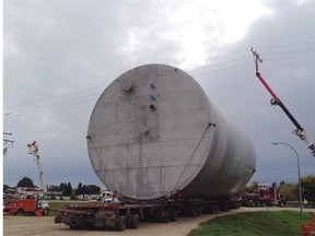 SaskPower crews lift power lines to allow large vessel to pass underneath. The 90,000 kg cylinder which is 20 metres long and nearly 12 metres in diameter will be moved by truck from Biggar to SaskPower’s Boundary Dam Power Station near Estevan this week. Credit SaskPower