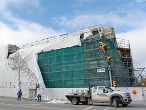 Scaffold workers deal with wind-damaged scaffold hanging off the Viterra building at the corner of Albert St. and Victoria Ave. in Regina, Sask. on Monday Oct. 12, 2015.
