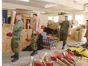 Soldiers of the Immediate Response Unit (West) receive their Personal Protective Equipment before deploying to support wildfire operations in Prince Albert, Saskatchewan, on July 7, 2015.