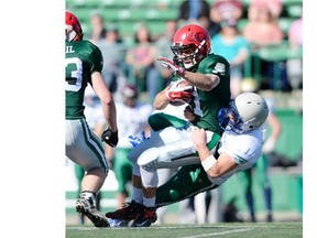 South Team runningback Ryan Schienbein (#21) is hauled down by North Team defensiveback Jace Peters (#24) in the twelve-man Senior Bowl game held at Mosaic Stadium in Regina on Monday May 18, 2015. (Michael Bell/Regina Leader-Post)