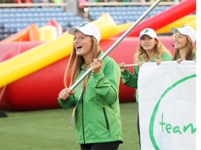 Team Saskatchewan flag bearer Lexy Vincent leads her province during the opening ceremonies of the 2015 Wood Buffalo Western Canada Summer Games in Fort McMurray Alta. on Friday August 7, 2015. Robert Murray/Fort McMurray Today/Postmedia Network