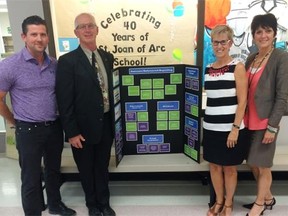 Three Regina Catholic School Division elementary schools have been making changes to how students are evaluated in grades 7 and 8 this year. Matt Brown, principal of St. Joan of Arc, from left, Len Thauberger, principal of St. Andrew and two of the division's superintendents of education services, Janet Chabot and Michele Braun pose in front of an outcomes-referenced reporting board on Friday.