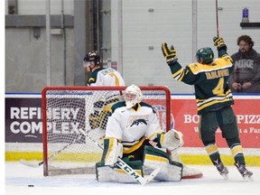 The University of Alberta Golden Bears’ Brennan Yadlowski celebrates one of his team’s goals while skating by University of Regina Cougars netminder Mitch Kilgore during a Canada West men’s hockey game Friday at the Co-operators Centre. The Golden Bears won 9-2.
