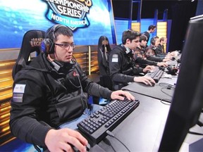 Venezuelan player Diego “Quas” Ruiz (L) of team “Curse”, prepares for the start of a match against “Cloud 9” during the League of Legends North American Championship Series Spring round robin competition, at the MBS Media Campus in Manhattan Beach, California on February 22, 2014.  League of Legends is the king of the hot trend in videogame play as a spectator sport, complete with sold-out stadiums and fans camping all night for tickets to matches.