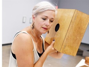 Wendy Peart, the Dunlop Art Gallery Curator of Education and Community Outreach with a piece of tactilely interactive art titled, A Case For Sound, by Toronto artist Marla Hlady in Regina on August 13, 2015. On Wednesday Peart is leading a “sensing art tour, Ó which is designed for people who are blind or have limited vision, of the gallery´s current exhibition Rhubarb, rhubarb, peas and carrots.