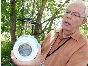 West Nile co-ordinator Phil Curry holds a mosquito trap while talking about West Nile in the province in Regina on June 26, 2015.