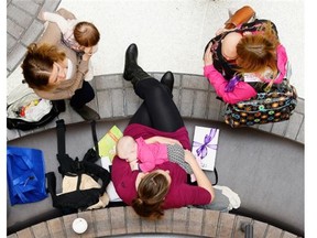 A woman breastfeeds her baby during a Quintessence World Record challenge held at the Cornwall Centre in Regina, Sask. on Saturday Oct. 3, 2015. The public “latch on” celebrates and promotes breastfeeding.