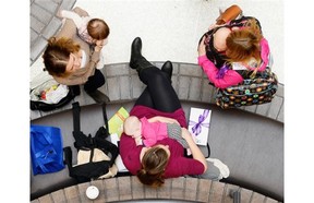 A woman breastfeeds her baby during a Quintessence World Record challenge held at the Cornwall Centre in Regina, Sask. on Saturday Oct. 3, 2015. The public “latch on” celebrates and promotes breastfeeding.