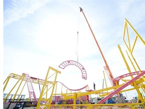 Workers take apart the Crazy Mouse roller coaster as the Queen City Ex wraps-up in Regina on Monday August 3, 2015.
