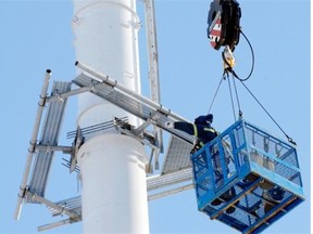 Working on a SaskTel cell tower in east Regina. SaskTel will get wireless spectrum from Wind to boost capacity on its 4G LTE network.  (Don Healy / Leader-Post)