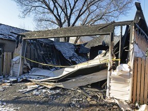 A garage sits destroyed by fire in the the alley at 200 block between St. John and Halifax St. in Regina, Sask. on Sunday Nov. 29, 2015.