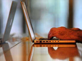 File — A man uses a laptop computer on July 1, 2009.