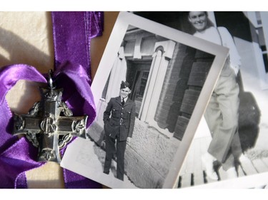 A medal sits among photographs of Lawrence Welsh at Claire White's (not pictured) home in Regina, Sask. on Wednesday Nov. 11, 2015. (Michael Bell/Regina Leader-Post)