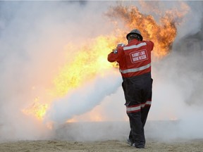 File — A member of the Rabbit Lake Mine Rescue (Cameco) control a fire during the Saskatchewan Mining Association Emergency Response/Mine Rescue Skills Competition held at Evraz Place in Regina on May 30, 2015.