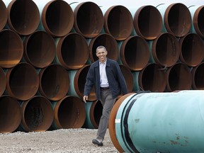 This March 22, 2012 file photo shows President Barack Obama arriving at the TransCanada Stillwater Pipe Yard in Cushing, Okla.