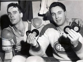 FOR USE WITH STUBBS COPY: Canadiens centreman Jean Béliveau holds up four pucks to mark his four-goal night in his team's 4-2 win over the Boston Bruins at the Montreal Forum on Nov. 5, 1955. At left is linemate and fellow future Hall of Famer Bert Olmstead. This was the second of Béliveau's 18 career hat tricks. Three of Béliveau's goals on this night came in a span of 44 seconds on the same power play. The NHL introduced a rule at the end of the 1955-56 season releasing a minor-penalized player from the box if a goal was scored by the team with the man advantage. MANDATORY CREDIT: DAVID BIER, GAZETTE FILES