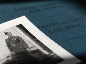 Bruce Walker's picture sits on top of his Pilot's Flying Log Book at Claire White's (not pictured) home in Regina, Sask. on Wednesday Nov. 11, 2015. Walker died August 8, 1944 when his plane was shot down over France. (Michael Bell/Regina Leader-Post)