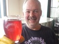 Bushwakker head brewer Mitch Dalymple holds up a glass of Blackberry Mead, which he begins making one year before its release.