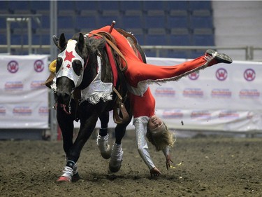 Cashlyn Krecklau, a rider with Calamity Cowgirls, performs a trick at Agribition at the Brandt Centre in Regina, Sask. on Saturday Nov. 28, 2015. (Michael Bell/Regina Leader-Post)