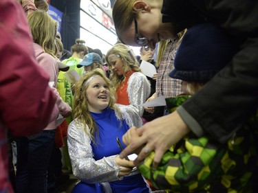 Casidy Ross, a rider with Calamity Cowgirls, signs autographs at Agribition at the Brandt Centre in Regina, Sask. on Saturday Nov. 28, 2015. (Michael Bell/Regina Leader-Post)