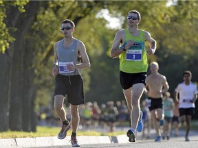 Iain Fyfe (#126) and Brendan Lunty (#1) lead the beginning of the Queen City Marathon in Wascana Centre in Regina, Sask. on Sunday Sep. 13, 2015.