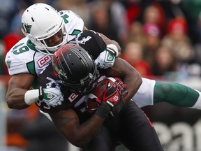 Saskatchewan Roughriders' Jeff Knox Jr., shown here tackling Calgary Stampeders' Jerome Messam during a CFL game on Oct. 31, 2015, has been nominated for three CFL awards.