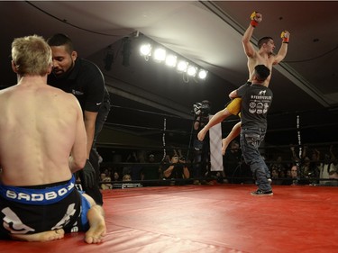 Matt Fedler, right, celebrates his win over Jesse Boldt, left, during their MMA fight at Saturday Night Fights held at the Conexus Arts Centre in Regina, Sask. on Saturday Nov. 14, 2015.