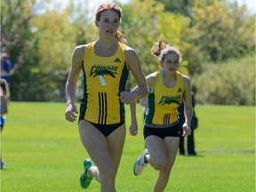 Anneliese Davis (left) and her sister Adriana (right), shown during the Cougar Trot on Sept. 12, 2015, are set to compete at the CIS cross-country championships Saturday.