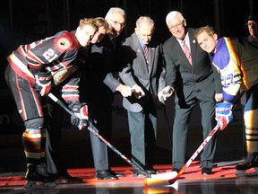 Del Wilson, centre, performs the ceremonial faceoff to begin the WHL's 50th-anniversary season Sept. 24 at Mosaic Place in Moose Jaw. The photo includes, from left to right, Brett Howden of the Moose Jaw Warriors, ex-Warrior Ryan Smyth, Moose Jaw-born Pats legend Clark Gillies, Wilson, WHL chairman of the board Bruce Hamilton and the Regina Pats' Adam Brooks.