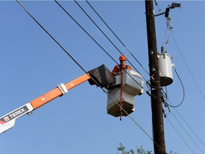 SaskPower crews repair damaged overhead power lines in Regina on Aug. 19, 2014.