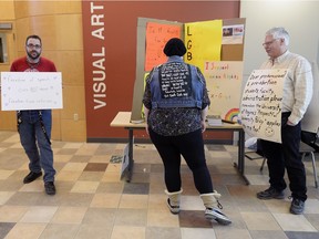 Bill Whatcott, right, wears a homemade sandwich board reminding people that he is allowed to be at the University of Regina on Monday.