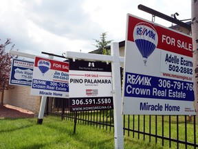 File — Home sale signs are pictured in Regina on July 07, 2015.