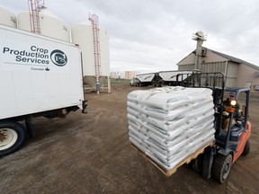 Rob Patterson moves bulk fertilizer at Crop Production Services, an Agrium crop input wholesaler in north Regina in this 2014 file photo. A decline in sales of agricultural supplies is being blamed for a small decline in wholesale trade in October.