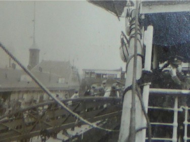 REGINA, SK : Nov. 9, 2015 -- A soldier (right) waves to the camera as a troopship docks in a British port. (Photo: William John Brake Collection 2 via Wayne MacDonald)