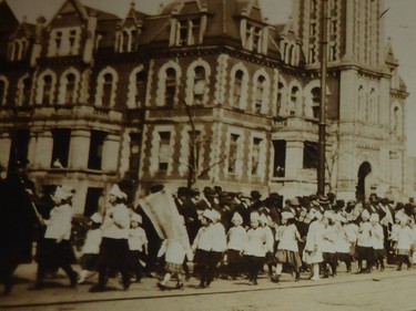 REGINA, SK : Nov. 9, 2015 -- Children file past past Regina's elegant old City Hall on 11th Avenue in a patriotic parade, likely in 1919. That building was demolished in the mid-1960s to make way for the Midtown Centre shopping mall, now the federal government's Alvin Hamilton Building. (Photo: William John Brake Collection 2 via Wayne MacDonald)