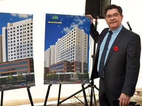 Namerind president and CEO Robert Byers beside design renderings for their planned mix-use head office building that is to be built in downtown Regina.