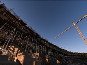 Crane operators work on the new stadium.