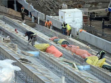 Workers lay the foundation for seating in the new stadium.