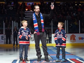 Josh Harding, shown with his nephews Ethan Palandri (left) and Gavin Le Brunoduring (right), prepares for the ceremonial faceoff at the Brandt Centre prior to a WHL game between the Red Deer Rebels and Regina Pats on Nov. 13, 2015. Harding, a former member of the Pats and NHL's Minnesota Wild, was honoured with a bobblehead.