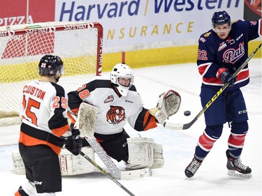Medicine Hat Tigers goalie Mack Shields makes the save as the Regina Pats' Rykr Cole tries to tip in the shot during first-period WHL action at the Brandt Centre on Tuesday.